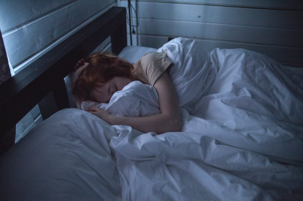 a lady sleeping on a bed
