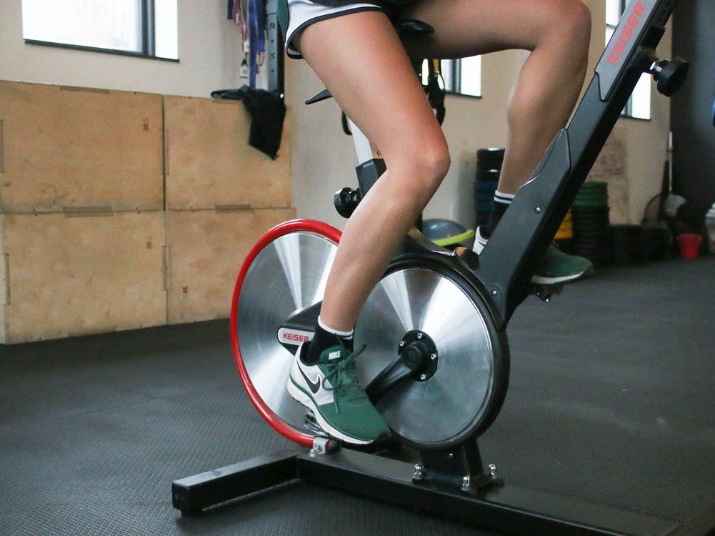 a person uses a stationary bike